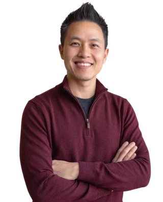 Symon He, smiling with his arms folded